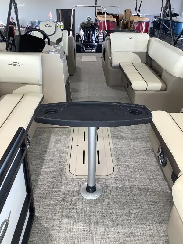 Slide: The Image of 2025 G3 SELECT 324SS boat interior with beige seating and central table. - 6
