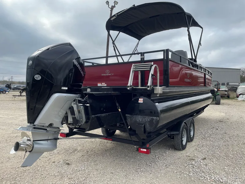 Slide: The Image of 2023 Regency 250 DL3 pontoon boat with outboard motor on trailer. - 4