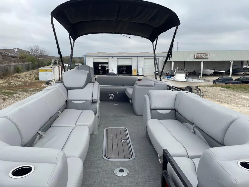 Slide: The Image of 2023 Regency 250 DL3 pontoon boat with spacious seating and canopy. - 8