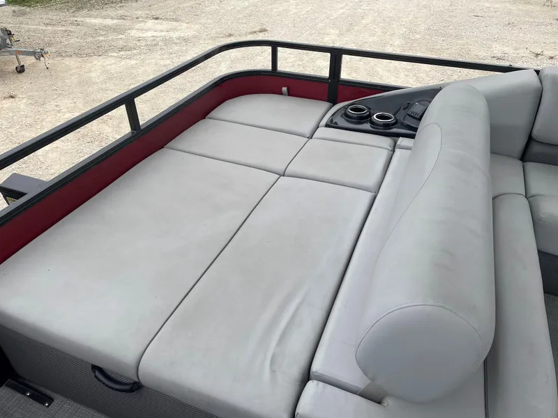 Slide: The Image of 2023 Regency 250 DL3 boat interior with gray seating and cup holders. - 10