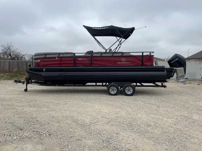 Slide: The Image of 2023 Regency 250 DL3 pontoon boat on trailer, red and black design. - 3