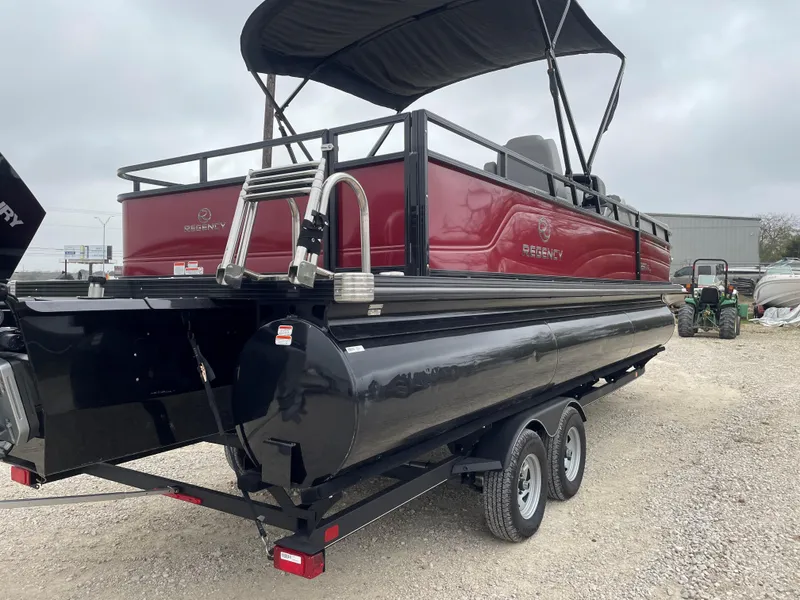 Slide: The Image of 2023 Regency 250 DL3 pontoon boat on trailer, red and black design. - 4