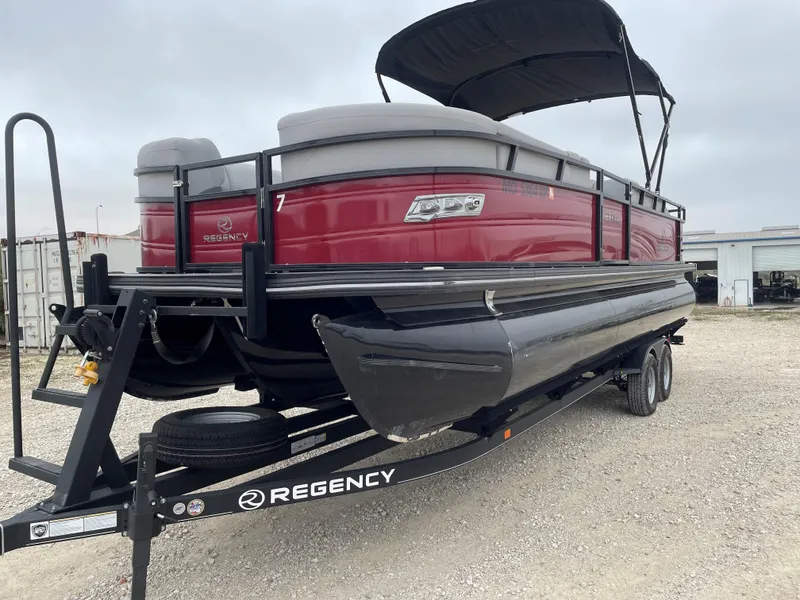 Slide: The Image of 2023 Regency 250 DL3 pontoon boat on trailer, red exterior, black canopy. - 6