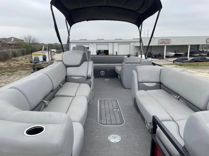 Slide: The Image of 2023 Regency 250 DL3 pontoon boat with spacious seating and canopy. - 9