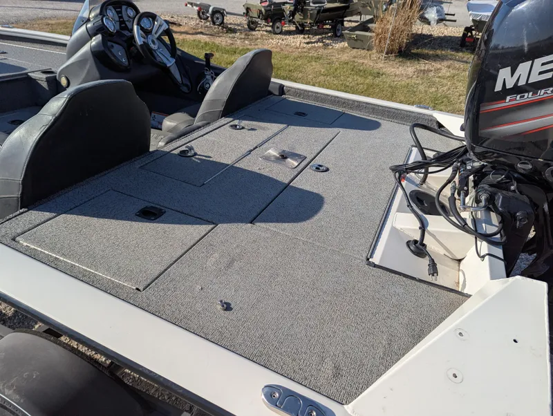 Slide: The Image of 2019 Tracker Pro Team 195 TXW Tournament Edition boat with Mercury engine, featuring spacious deck. - 16