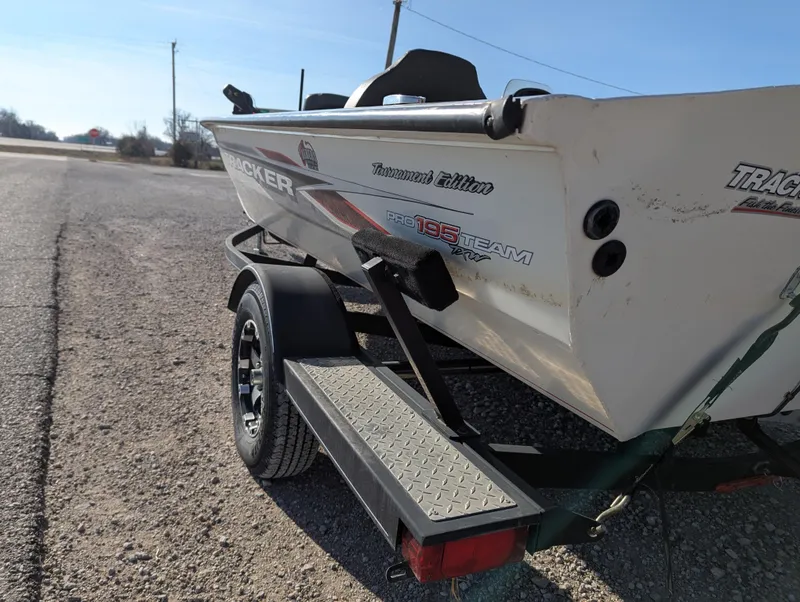 Slide: The Image of 2019 Tracker Pro Team 195 TXW Tournament Edition boat on trailer, parked on roadside. - 4