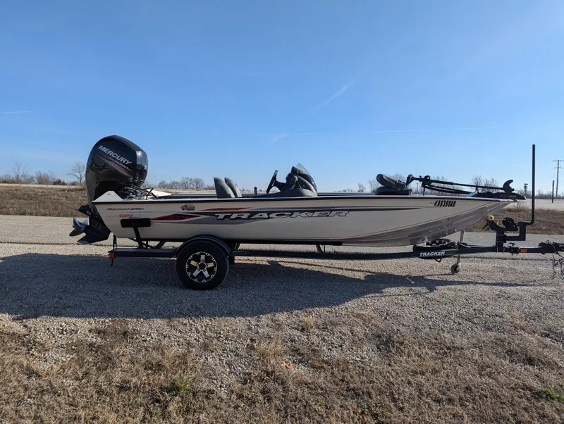 Slide: The Image of 2019 Tracker Pro Team 195 TXW Tournament Edition boat on trailer, parked outdoors. - 8