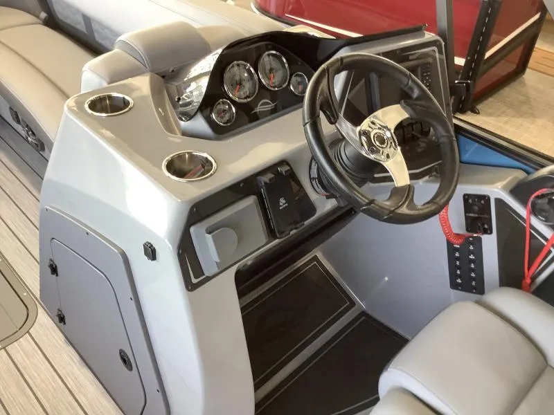 Slide: The Image of 2025 G3 FUSION 324SS boat dashboard with steering wheel and gauges. - 22