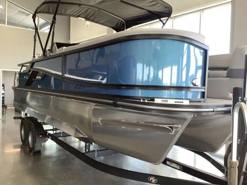 Slide: The Image of 2025 G3 FUSION 324SS pontoon boat with blue and silver design on trailer. - 3