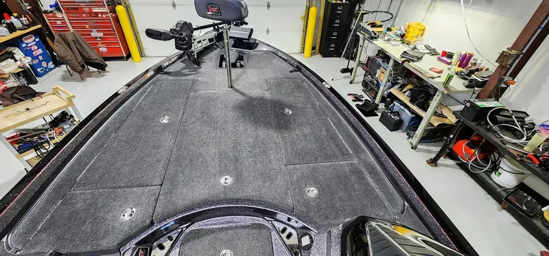 Slide: The Image of 2019 Ranger Z521L boat interior in a garage workshop setting. - 7