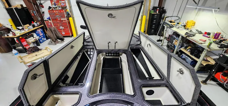 Slide: The Image of 2019 Ranger Z521L boat interior with open storage compartments in a workshop setting. - 8