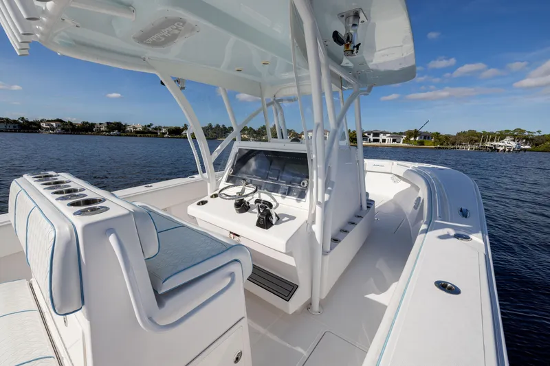 Slide: The Image of 2018 SeaHunter 33' Center Console boat on calm water, featuring a sleek helm and seating. - 10