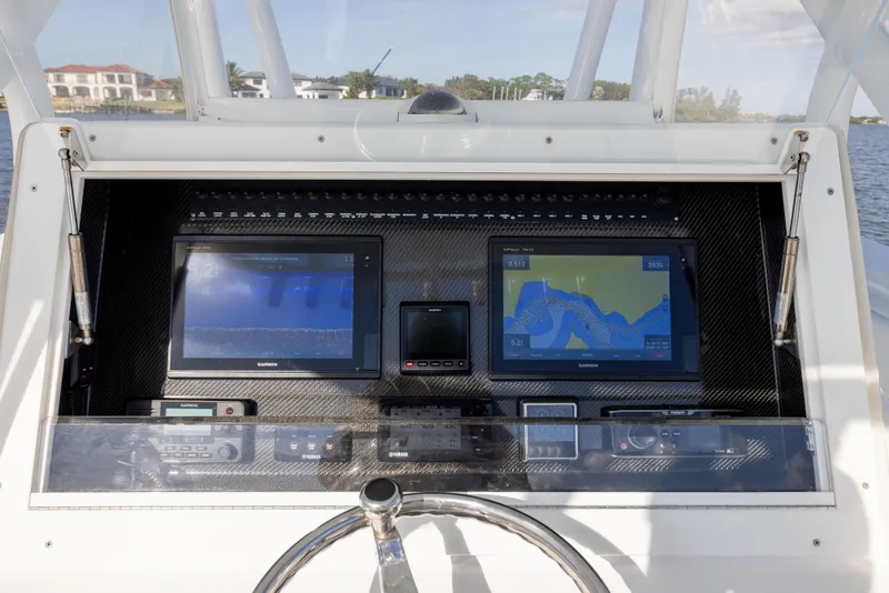 Slide: The Image of 2018 SeaHunter 33' Center Console dashboard with navigation screens and controls. - 11