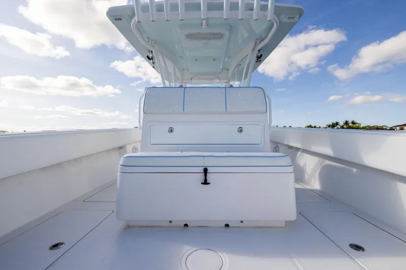 Slide: The Image of 2018 SeaHunter 33' Center Console boat, spacious deck under clear blue sky. - 16
