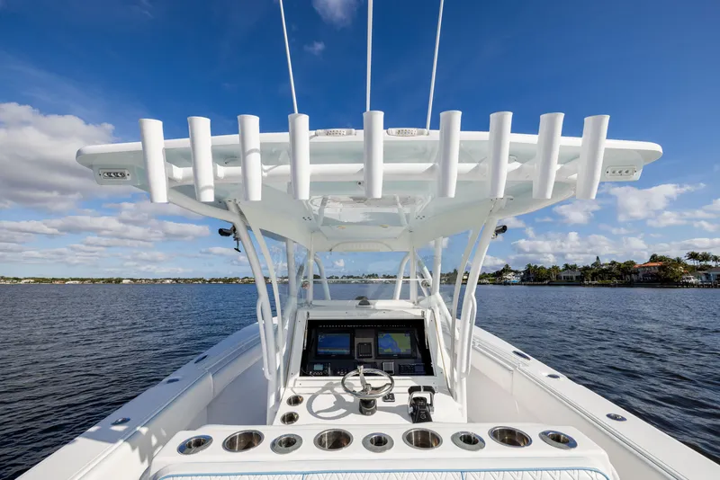 Slide: The Image of 2018 SeaHunter 33' Center Console boat on calm water under blue sky. - 18