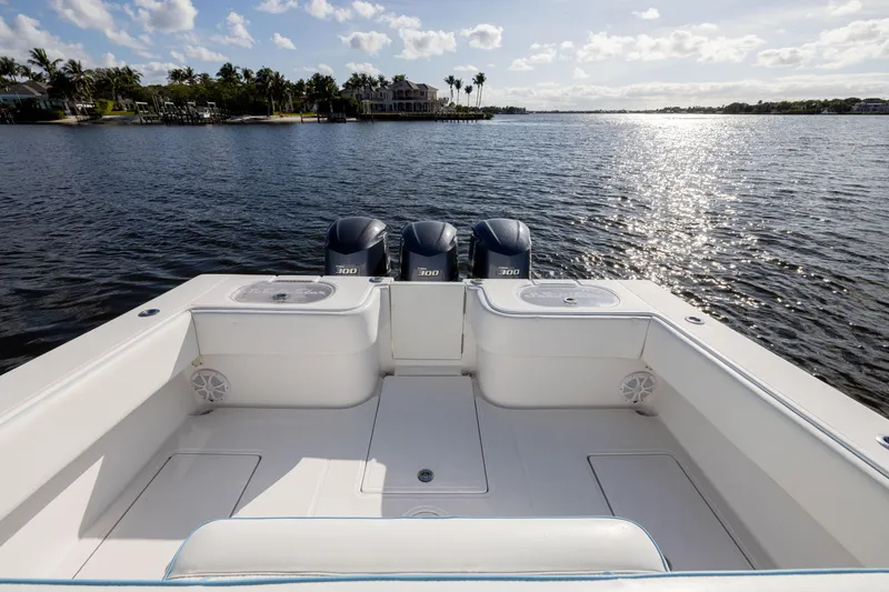 Slide: The Image of 2018 SeaHunter 33' Center Console boat with triple engines on a sunny lake. - 24