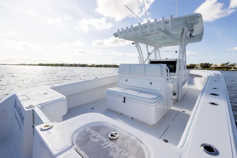 Slide: The Image of 2018 SeaHunter 33' Center Console boat on open water, sunny day. - 25