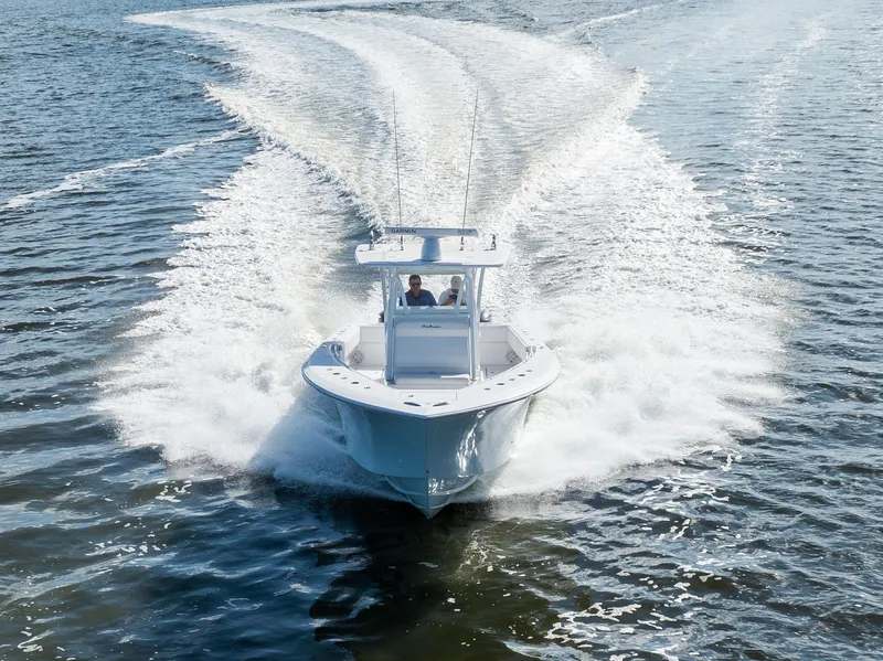 Slide: The Image of 2018 SeaHunter 33' Center Console boat cruising on open water. - 33