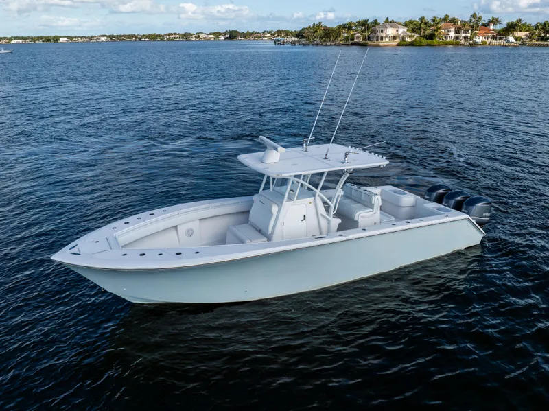 Slide: The Image of 2018 SeaHunter 33' Center Console boat on calm water. - 38