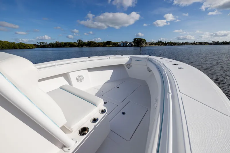Slide: The Image of 2018 SeaHunter 33' Center Console boat on calm water, clear sky. - 6