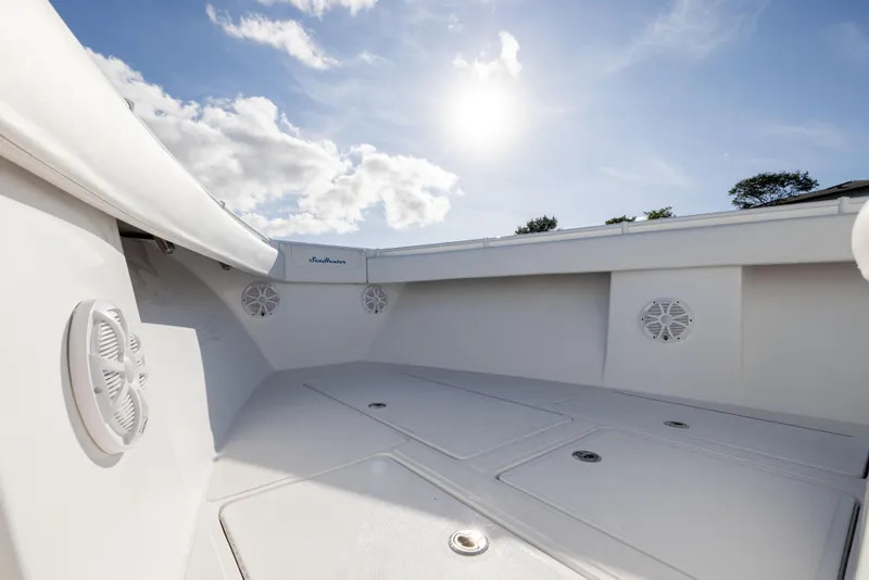Slide: The Image of 2018 SeaHunter 33' Center Console boat interior under sunny sky. - 7