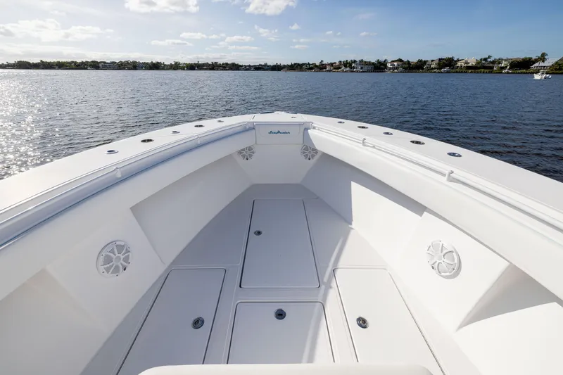 Slide: The Image of 2018 SeaHunter 33' Center Console boat on calm water, showcasing spacious deck. - 8