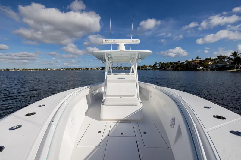 Slide: The Image of 2018 SeaHunter 33' Center Console boat on calm water under blue sky. - 9