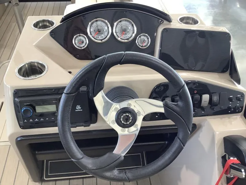 Slide: The Image of 2025 G3 Select 322SS boat dashboard with steering wheel and control panel. - 10