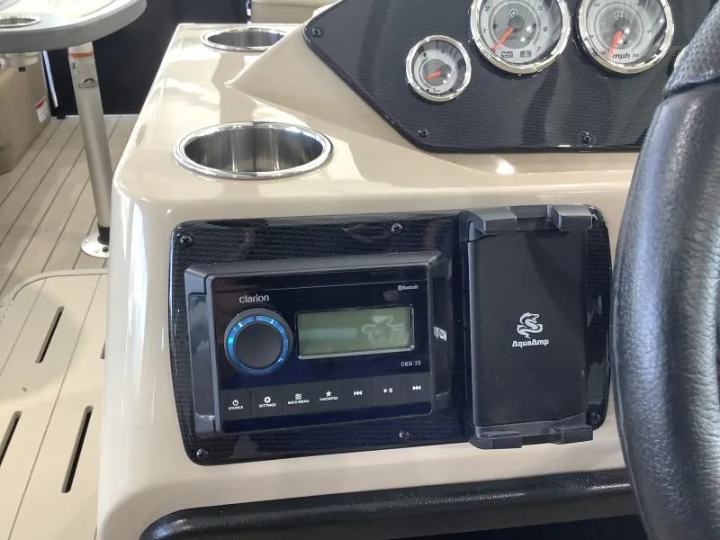Slide: The Image of 2025 G3 Select 322SS boat dashboard with Clarion audio system and gauges. - 13
