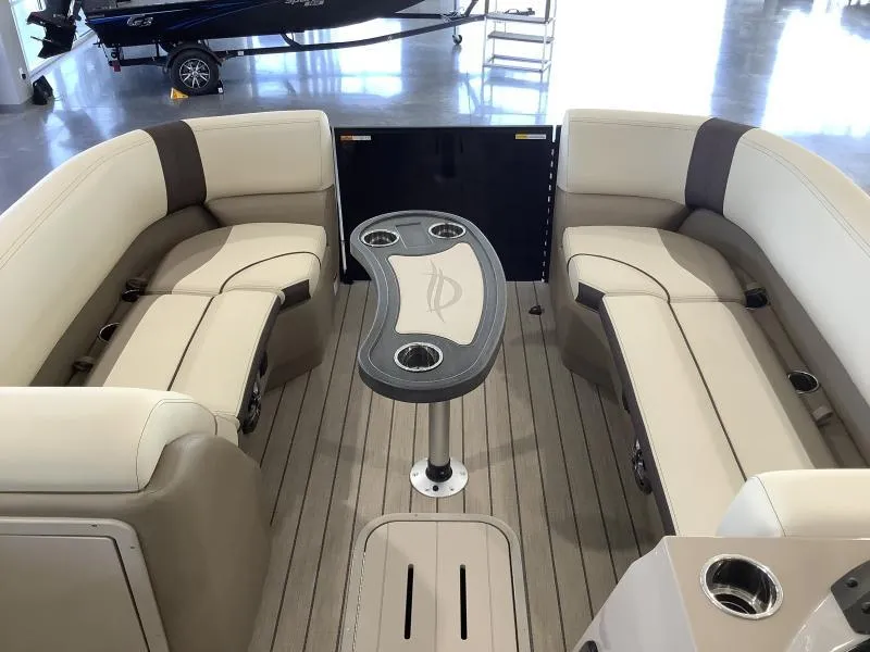 Slide: The Image of 2025 G3 Select 322SS boat interior with beige seating and central table. - 16