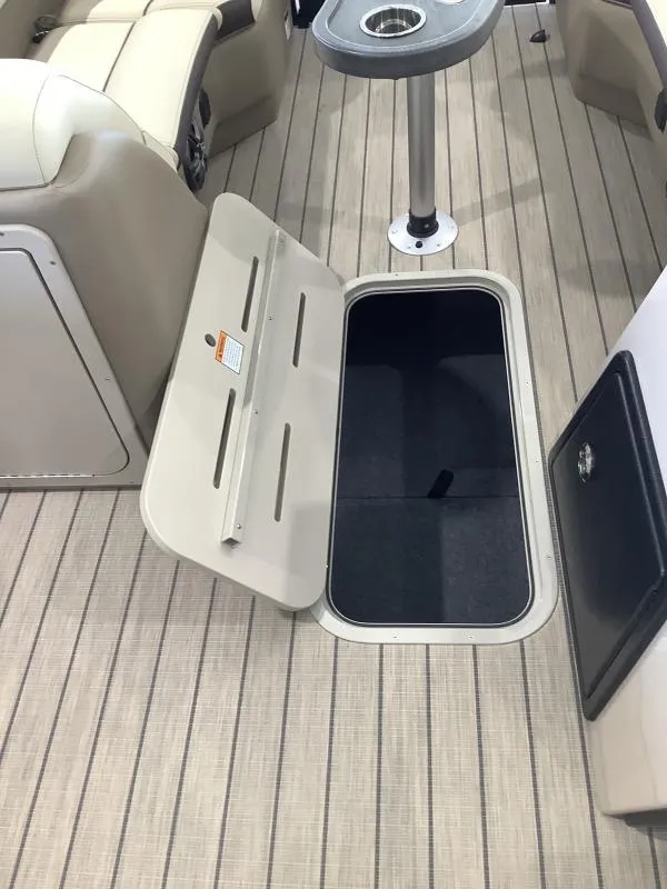Slide: The Image of 2025 G3 Select 322SS boat interior with open storage compartment on deck. - 17