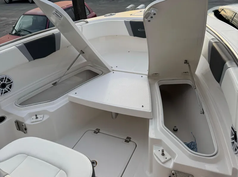 Slide: The Image of 2022 Robalo R230 Center Console boat with open storage compartments. - 10