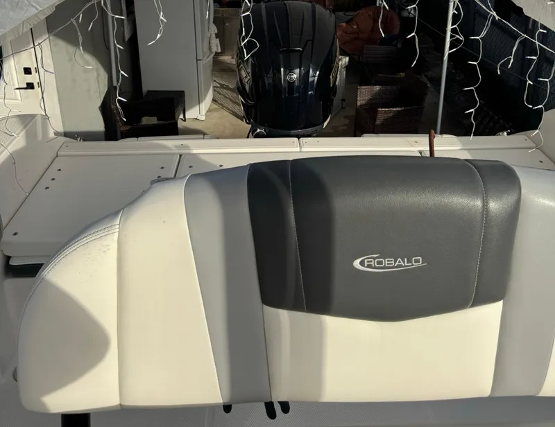 Slide: The Image of 2022 Robalo R230 Center Console boat interior with seating and motor. - 5