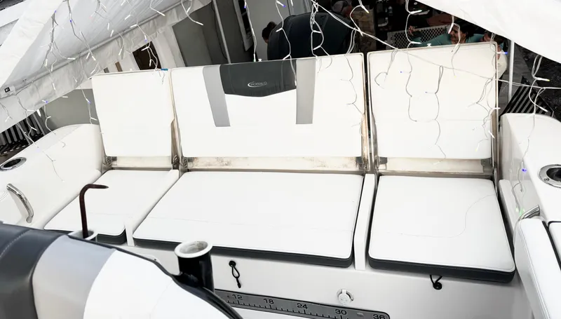 Slide: The Image of 2022 Robalo R230 Center Console boat seating area with white cushions. - 6