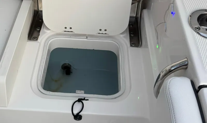 Slide: The Image of Open storage compartment on 2022 Robalo R230 Center Console boat. - 7