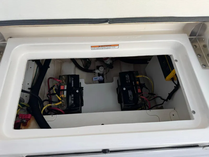 Slide: The Image of 2022 Robalo R230 Center Console battery compartment with dual batteries. - 8