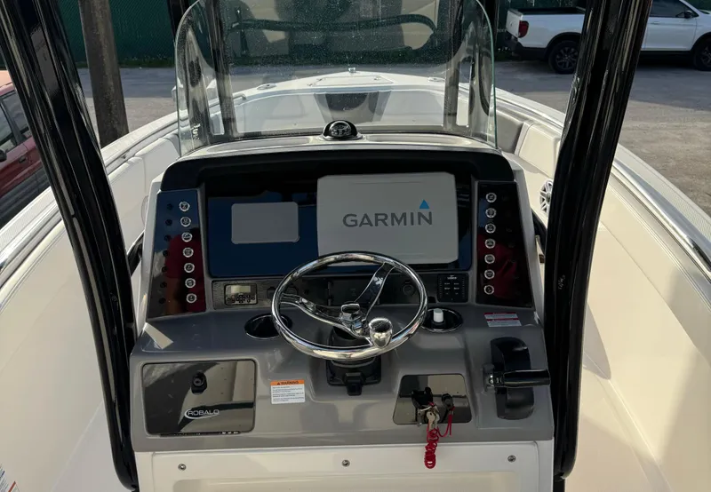 Slide: The Image of 2022 Robalo R230 Center Console boat dashboard with Garmin navigation system. - 9