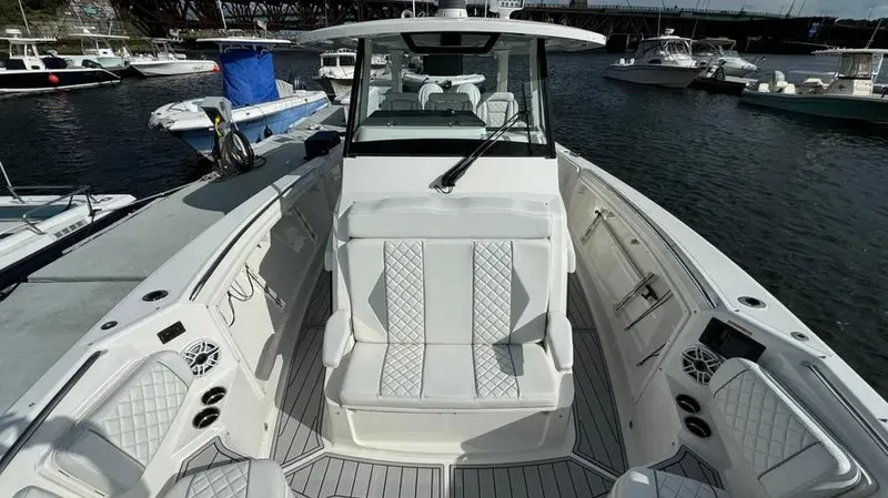 Slide: The Image of 2022 Pursuit S 358 Sport boat interior with luxurious seating and modern design. - 11