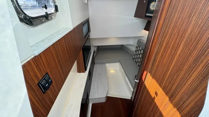 Slide: The Image of 2022 Pursuit S 358 Sport cabin interior with wood accents and modern design. - 16