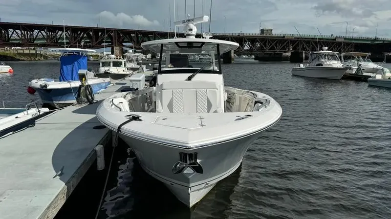 Slide: The Image of 2022 Pursuit S 358 Sport boat docked in marina. - 2