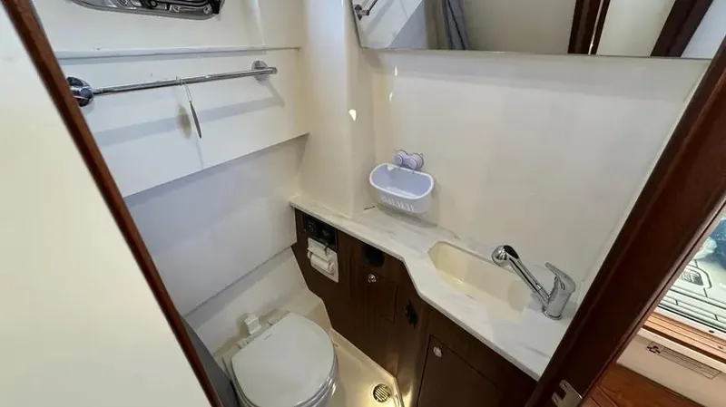 Slide: The Image of 2022 Pursuit S 358 Sport boat bathroom with sink, toilet, and storage. - 20