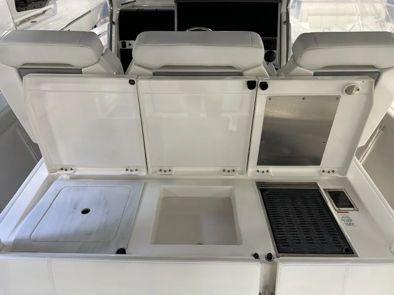 Slide: The Image of 2022 Pursuit S 358 Sport boat interior with open storage compartments and seating. - 27