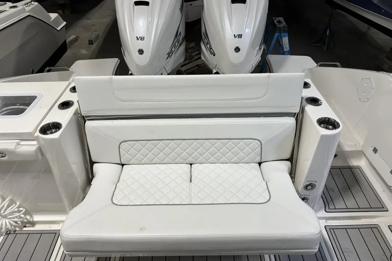 Slide: The Image of 2022 Pursuit S 358 Sport boat with white cushioned seating and twin V8 engines. - 29