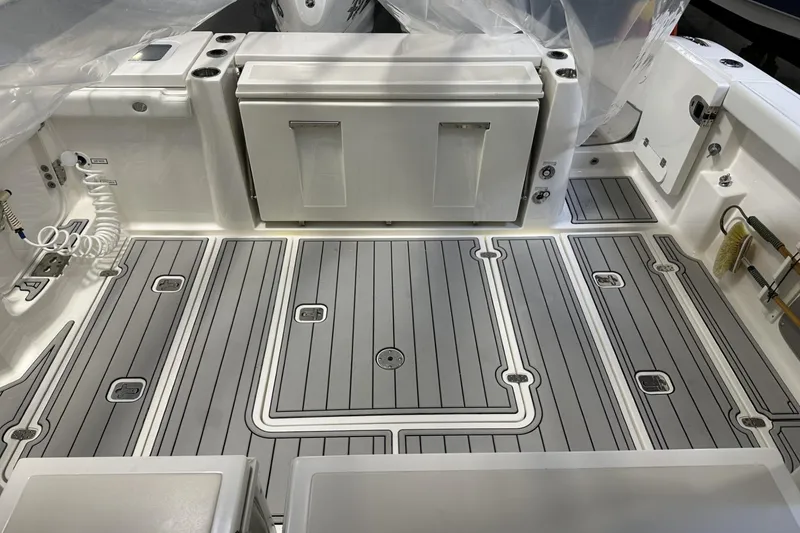 Slide: The Image of 2022 Pursuit S 358 Sport boat deck with sleek, modern design and storage compartments. - 31