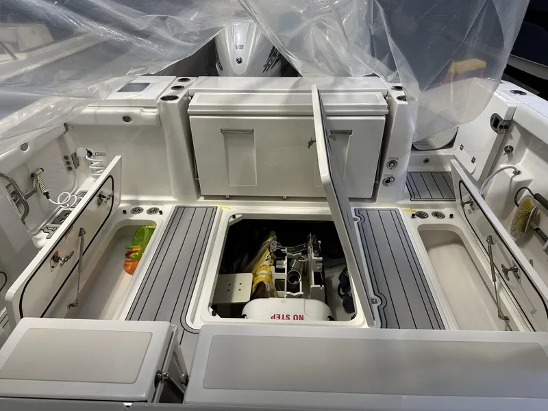 Slide: The Image of 2022 Pursuit S 358 Sport boat interior with open storage compartments. - 32