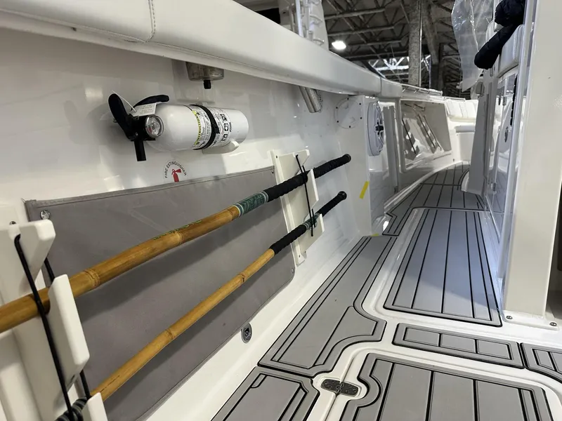 Slide: The Image of 2022 Pursuit S 358 Sport boat interior with fishing rod holders and non-slip deck. - 33