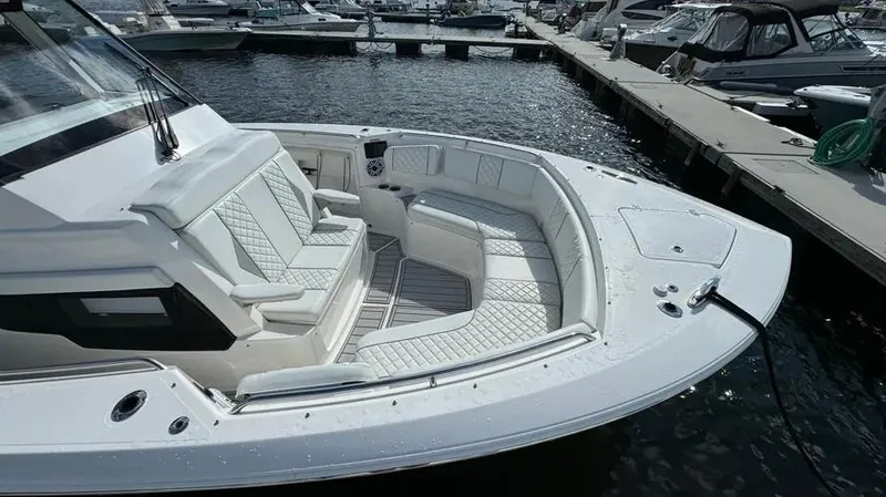 Slide: The Image of 2022 Pursuit S 358 Sport boat with spacious seating at marina. - 4