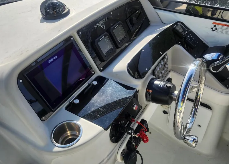 Slide: The Image of 2008 Formula 330 Sun Sport dashboard with steering wheel and navigation controls. - 10
