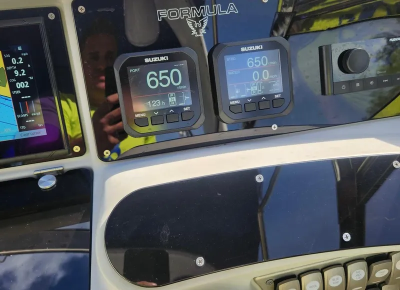 Slide: The Image of Dashboard of a 2008 Formula 330 Sun Sport boat with Suzuki displays. - 12
