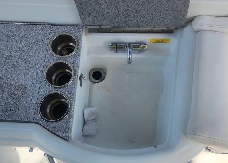 Slide: The Image of 2008 Formula 330 Sun Sport boat sink with cup holders and faucet. - 13